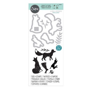 May include: A set of seven metal dies and six stamps featuring a fox, leaves, and a moon. The dies are silver and the stamps are black. The text on the packaging reads "7 Dies - 6 Stamps | 7 Matrices - 6 Tampons | 7 Troqueles - 6 Sellos | 7 Fustelle - 6 Timbri | 7 Вырубки - 6 Печати | 7 Stanzen - 6 Stempel | 7 Cortantes - 6 Carimbos".