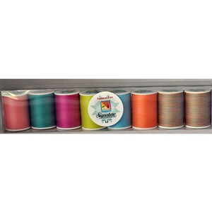 May include: A clear plastic box containing eight spools of sewing thread in various colors including pink, teal, magenta, lime green, blue, orange, and two multi-colored striped spools. A circular label reads Summer Fun Signature.