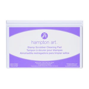 May include: A rectangular white Hampton Art stamp scrubber cleaning pad with a purple oval center. The label features the text: Hampton Art, Stamp Scrubber Cleaning Pad, Works on clear, rubber, cling & foam stamps, and Cleans & Protects.