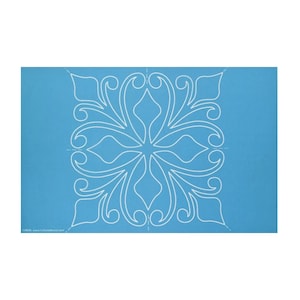 May include: A blue quilting template with a white floral design. The template is used for quilting and crafting.