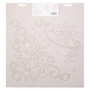 May include: A beige stencil with a corner design featuring floral and swirling patterns. The stencil has a rectangular shape with two small holes at the top for hanging. A small label with text is visible in the upper right corner.