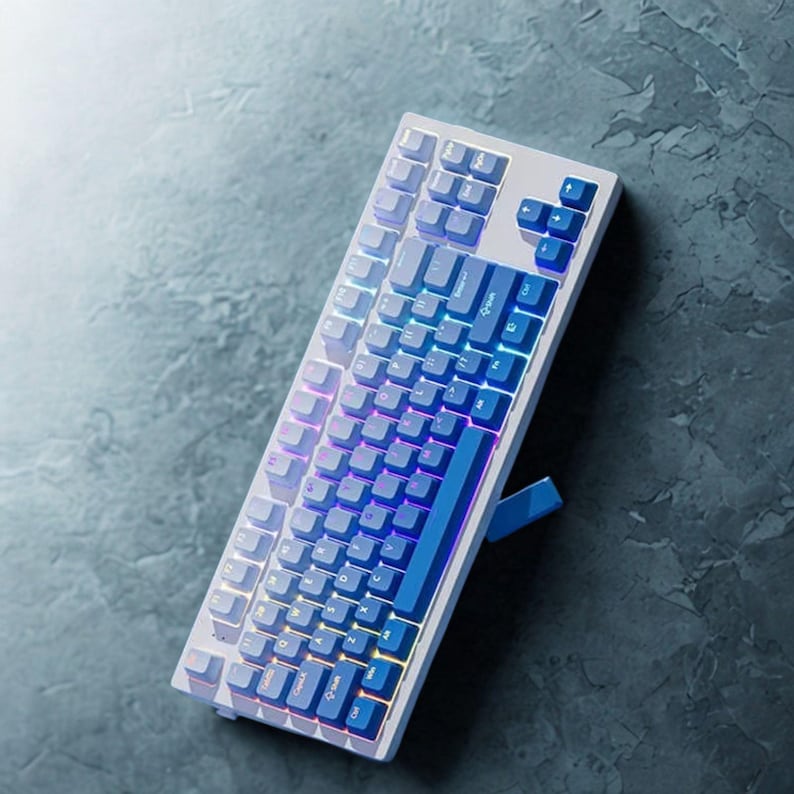 OEM profile gradient blue PBT keycaps arranged neatly on keycap tray.
