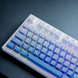 Mechanical keyboard with light-blue to navy gradient keycaps and RGB glow.