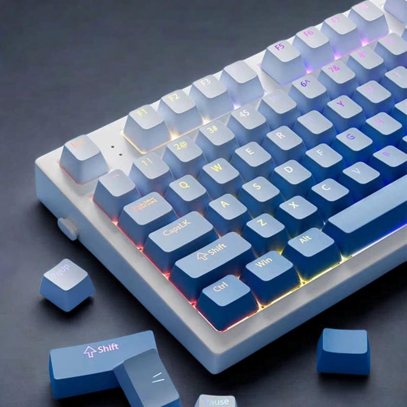 Gradient blue translucent PBT keycaps on mechanical keyboard with RGB lighting.