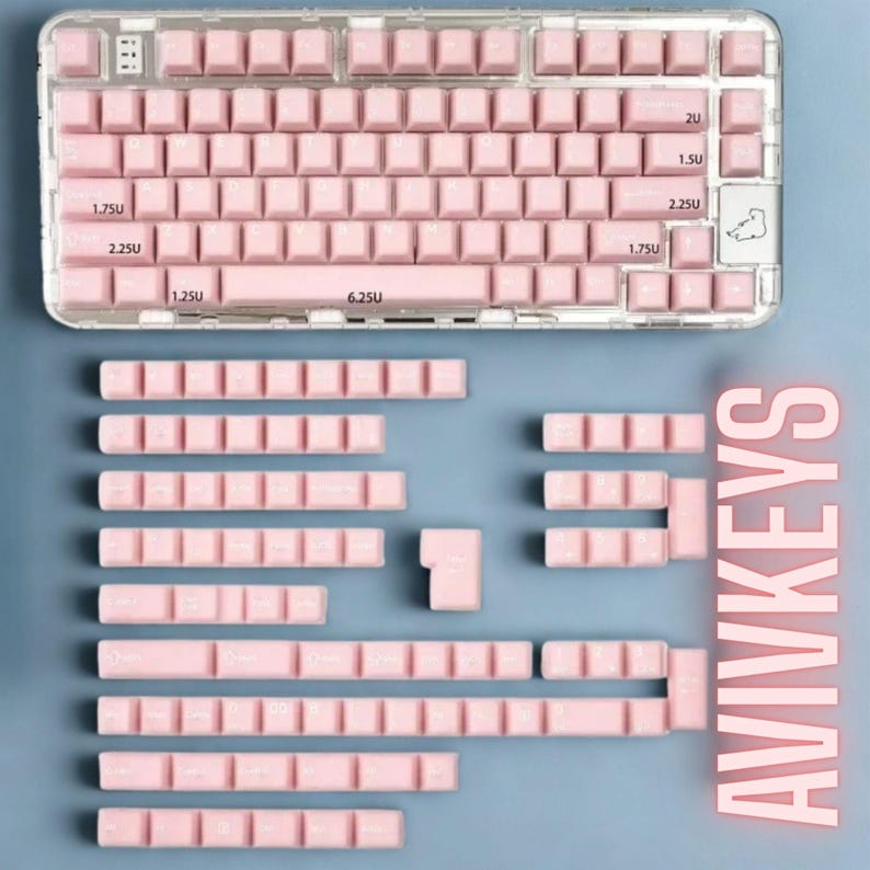 May include: A clear, rectangular keyboard with pink keycaps and a matching set of replacement keycaps. The keyboard has a clear frame and is set against a blue background. The text "AVIVKEYS" is displayed vertically.