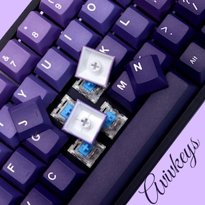 Gradient purple keycaps displayed on desk – 108-key layout for mechanical keyboard