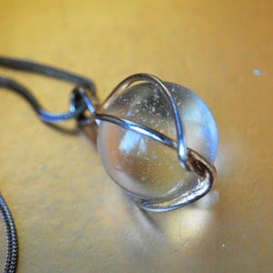 Mod  vintage 70s gold tone metal with a bronze finished necklace and wire wrapped, clear art glass, ball pendant.