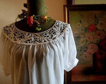 1970 vintage  crisp  white  rayon  peasant style blouse with  boat neck line, french lace,  short  raglan  puffy sleeves. Size Medium.