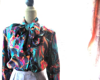 Equestrian  vintage 80s, black silk blouse with a bright multi color print and tie-bow. Made by Doncaster. Size 6. Mint condition.