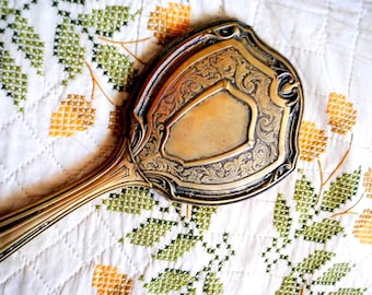 1900 silverplated hand-held   vanity mirror  with  intricate  floral an scrollwork design,  art nouveau style.