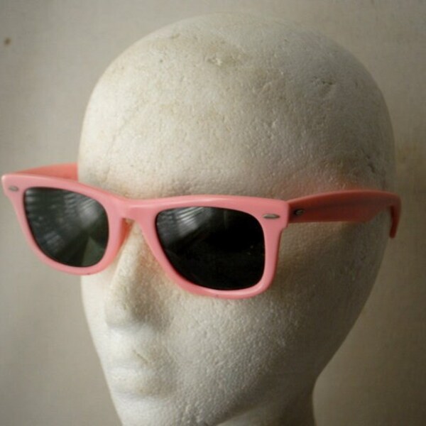 1984  vintage , bubblegum pink heavy plastic  sunglasses with dark green lenses. Made  by Wayfarer, Ray-Ban in USA, Model 5022.