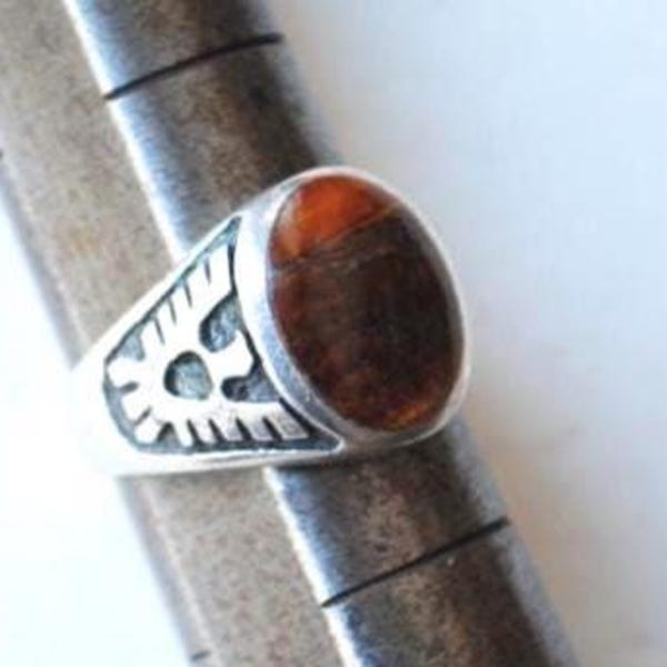 1970  sterling silver 925 men's  ring  with a natural   tiger's eye  gemstone  and a distinctive  thunderbird  design  on the band, size 10.