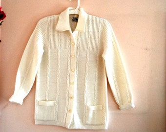 Cute  vintage 1960s white acrylic  ribbed with a cable knit sweater-cardigan. Made by Cuddle Knit. Size M.