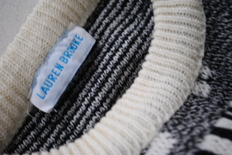 Novelty vintage 80s white acrylic slouchy sweater with a gray and black news paper print.Made Lauren Brook Size M.