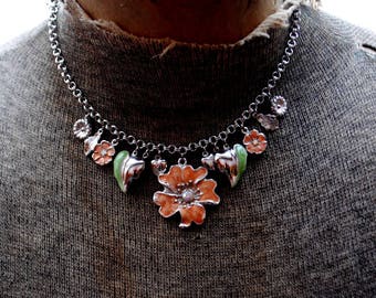 Collar bohemio vintage de los años 70, de metal plateado con flores, hojas y dijes de perla. Fabricado en 1928.