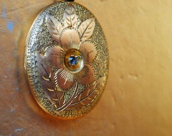 Art nouveau vintage 1910 s ,   rose gold plated  , oval shape locket pendant  with a   hand etched flower and leaves. By  S.B. Co.