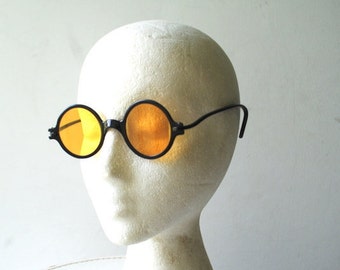 Art deco vintage 1920s, black faux tortoise , round, flat , light brown-amber lenses , unisex sunglasses.