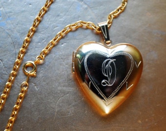 1970 vintage , bohemian  style  , gold tone metal necklace with  , large puffy heart locket pendant and  engraved letter D on the  front.