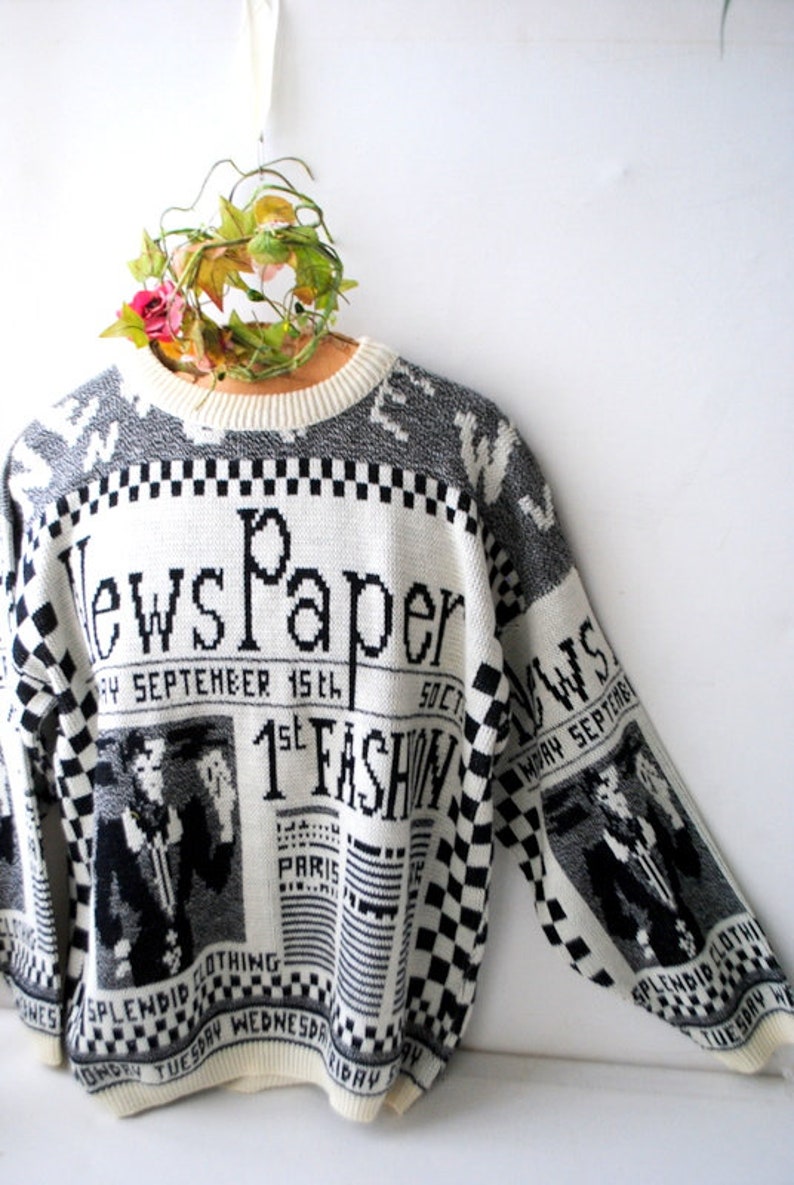 Novelty vintage 80s white acrylic slouchy sweater with a gray and black news paper print.Made Lauren Brook Size M.