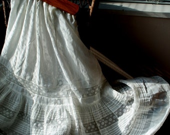 1900 vintage , white  thin  cotton,  Edwardian  style petticoat  with a  delicate net lace panels  and multi pin tacks. Size S-M.