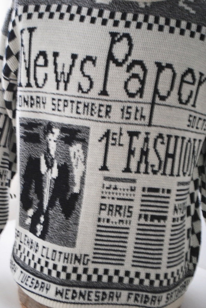 Novelty vintage 80s white acrylic slouchy sweater with a gray and black news paper print.Made Lauren Brook Size M.
