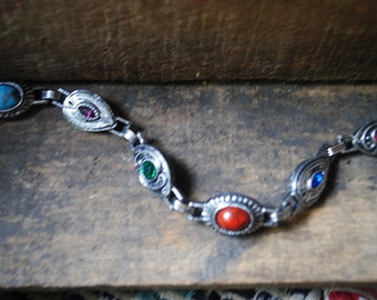 Boho vintage 70s silvertone metal bracelet with ornate links and multicolor stones. Made by Sarah Covntry. Size 7 1/2