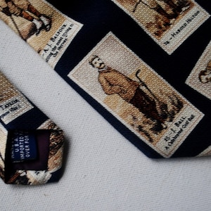 1980 vintage ,  souvenir , rare  , navy  blue  , hand  sewn necktie  with beige  print of  the  famous  late 1800&#39;s golfers. By Lands&#39;  End.