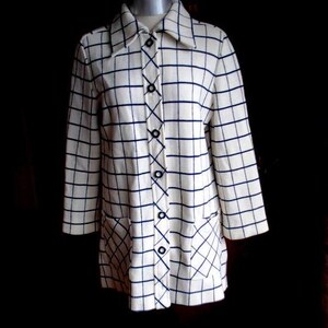 May include: A white and blue checkered long-sleeved jacket with a button-up front and a collar. The jacket has two pockets on the front.