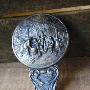 Country folk vintage 50s, silverplated hand held , small , round mirror with a 3d repousse  . Made by Hans Jensen , Denmark.