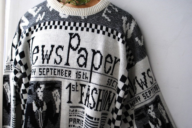 Novelty vintage 80s white acrylic slouchy sweater with a gray and black news paper print.Made Lauren Brook Size M.