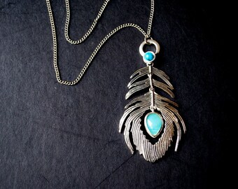 Boho vintage 1990s, silver tone metal necklace  with a a feather texture  dangle vertical pendant ,  faux turquoise, and aqua  blue lucite.