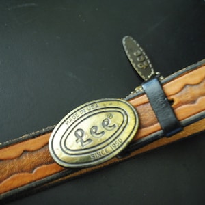 Boho vintage 70s caramel brown, genuine tooled leather, womens belt with oval shape, brass ,Lee buckle. image 1
