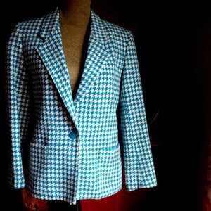 May include: A blue and white houndstooth blazer with a single button closure.