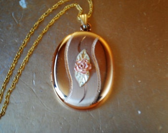 1980 luxurious  vintage   14 k gold plated,   oval locket pendant with  3d rose, 12 k gold plated chain. By Landstrom's , Black  Hills.