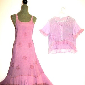 May include: A pink sleeveless maxi dress with a floral pattern and a ruffled hem. A matching pink cropped cardigan with a button closure is also included.