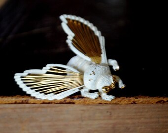 Sweet vintage 1960,  gold tone metal Bumble  Bee brooch with a white enamel details.  Made by Monet.