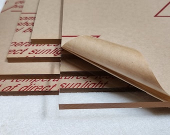 May include: Stack of brown acrylic sheets with protective paper covering. The paper has the text "Store in temperatures below 140 degrees F (60 degrees C) and out of direct sunlight" printed in red. The top sheet has a red triangle with the text "Clean with mild detergent; do not use abrasive cleaners" printed in red.