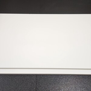 May include: Two white foam core boards stacked on top of each other. The boards are rectangular and have a smooth surface.