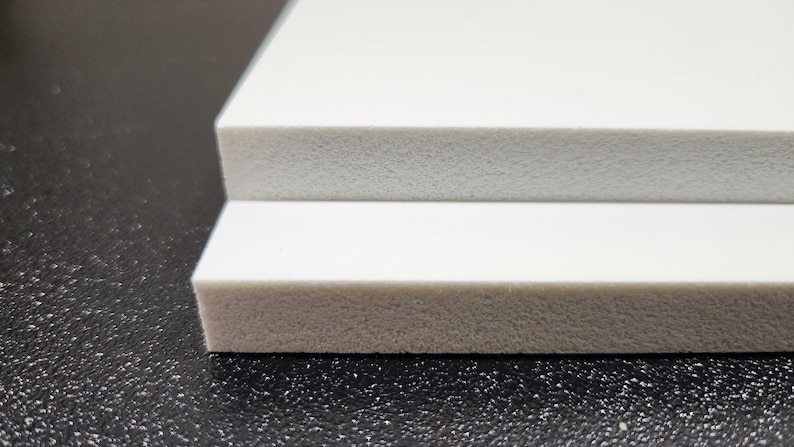 May include: Two white foam boards stacked on top of each other. The boards are smooth and have a slightly textured surface.