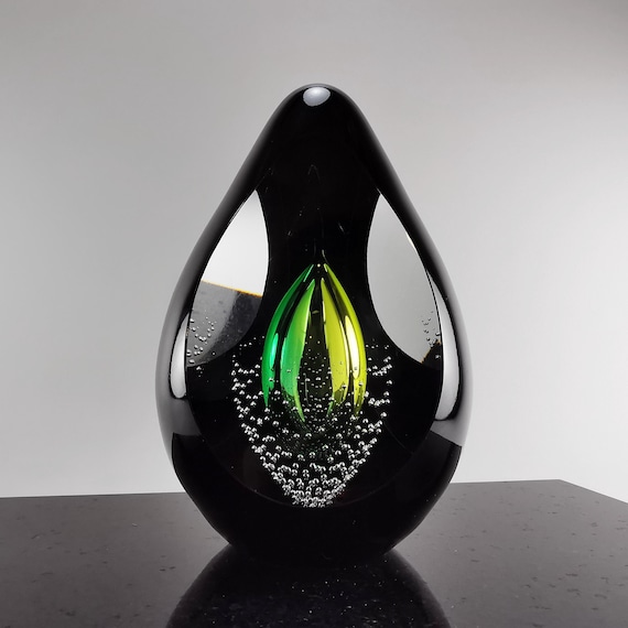 Sleek, hand-blown black glass sculpture that looks like it belongs in a contemporary gallery, not a craft fair.