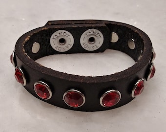 Leather cuff with red rhinestone studs