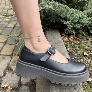 May include: A trio of ceramic mugs with a speckled, matte finish in cream, light grey, and dark grey. Each mug features a simple, minimalist design and a rounded handle.