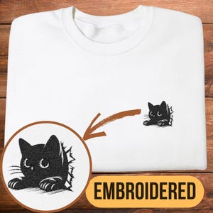 Mischievous Black Cat Sweatshirt, Embroidered Kitten Tore Pocket Design, Cozy Cat Lover Crewneck
