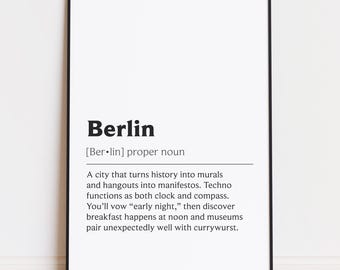 May include: A framed print with the word "Berlin" in bold black font, followed by a definition. The text describes Berlin as a city that turns history into murals and hangouts into manifestos.
