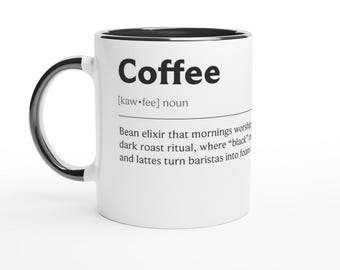 May include: White coffee mug with a black handle and rim. The mug features the word "Coffee" in bold black letters, along with a definition that describes coffee as a morning ritual.