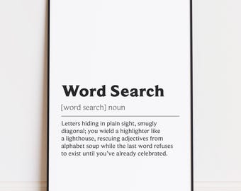 May include: A framed print with the words "Word Search" in bold black font. Below, a definition describes the activity of finding words. The print is in a black frame and is displayed against a white wall.