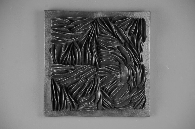 May include: Black and white abstract wall art with a textured, layered design. The art is framed in a black wood frame.