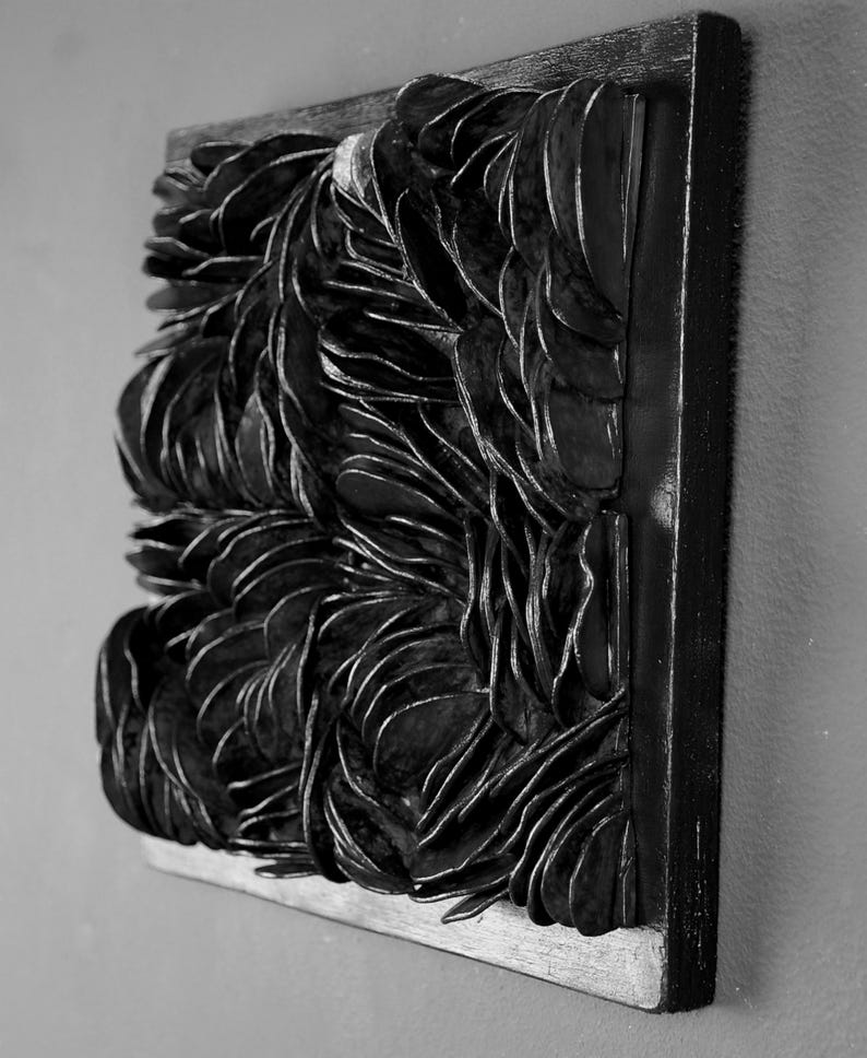 May include: Black and white abstract wall art made of layered, overlapping shapes. The artwork is framed in a black wood frame.