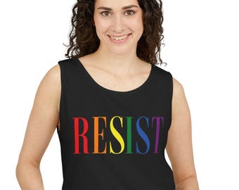 May include: Black tank top with the word "RESIST" in rainbow colors across the front. The text is in a bold, sans-serif font. The tank top is sleeveless and has a scoop neckline.