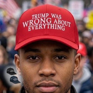 May include: Red trucker hat with white text that reads "TRUMP WAS WRONG ABOUT EVERYTHING." The hat has a mesh back and a curved brim. The image also shows two other hats, one black and one navy blue, with the same text.